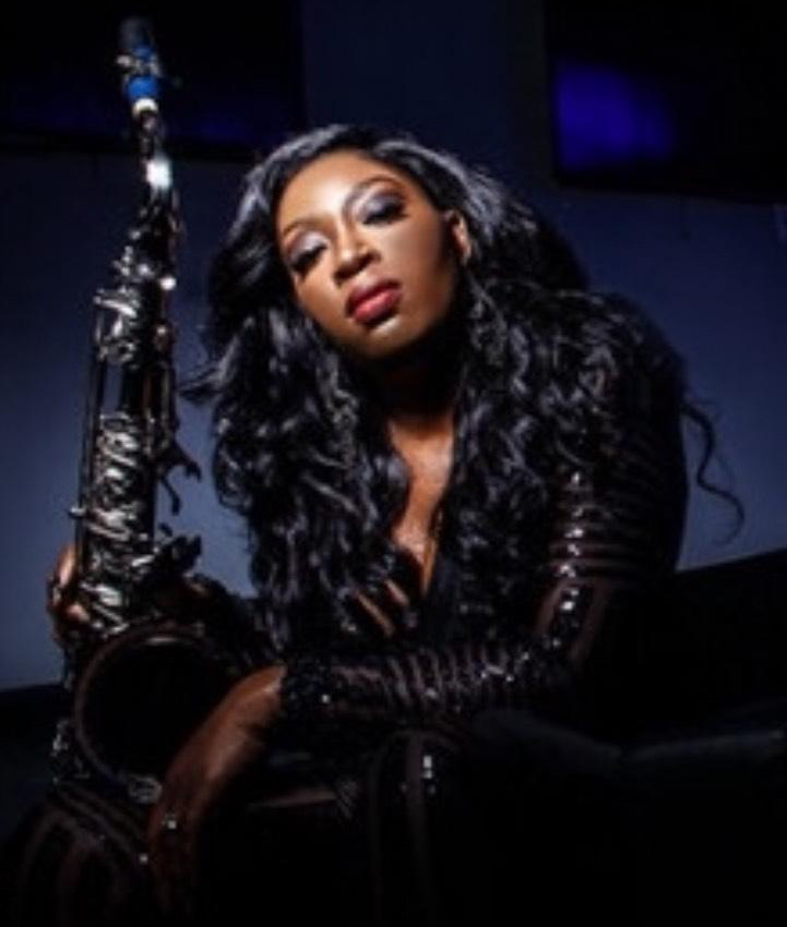 Charmin Greene poses with her saxophone.